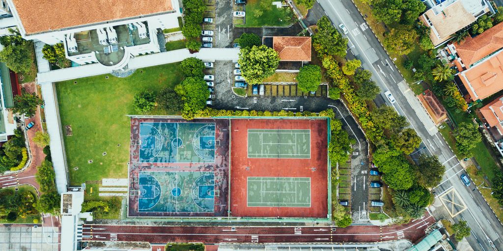 aerial photography of four basketball courts